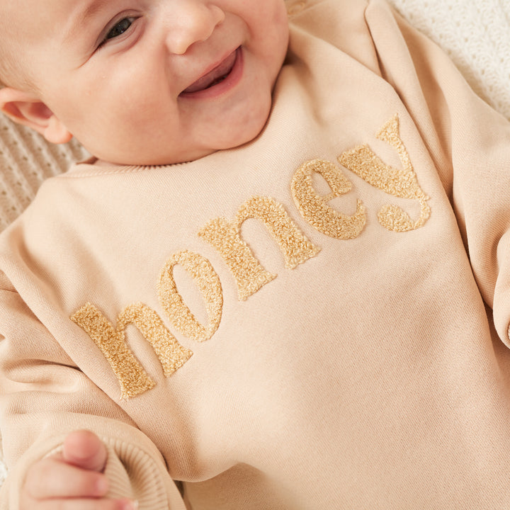 unisex baby oatmeal romper with honey text