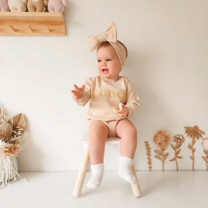 unisex baby oatmeal romper with honey text